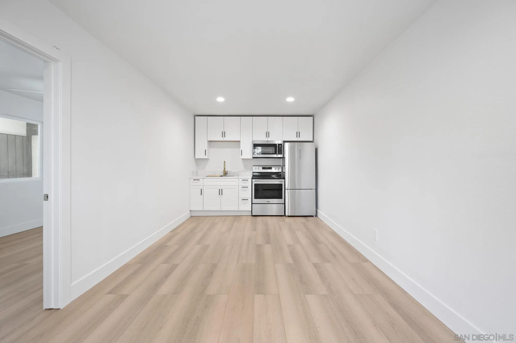 329 North Pico Avenue Fallbrook, CA 92028 - Photo 16 of 23 a view of a kitchen with wooden floor and electronic appliances