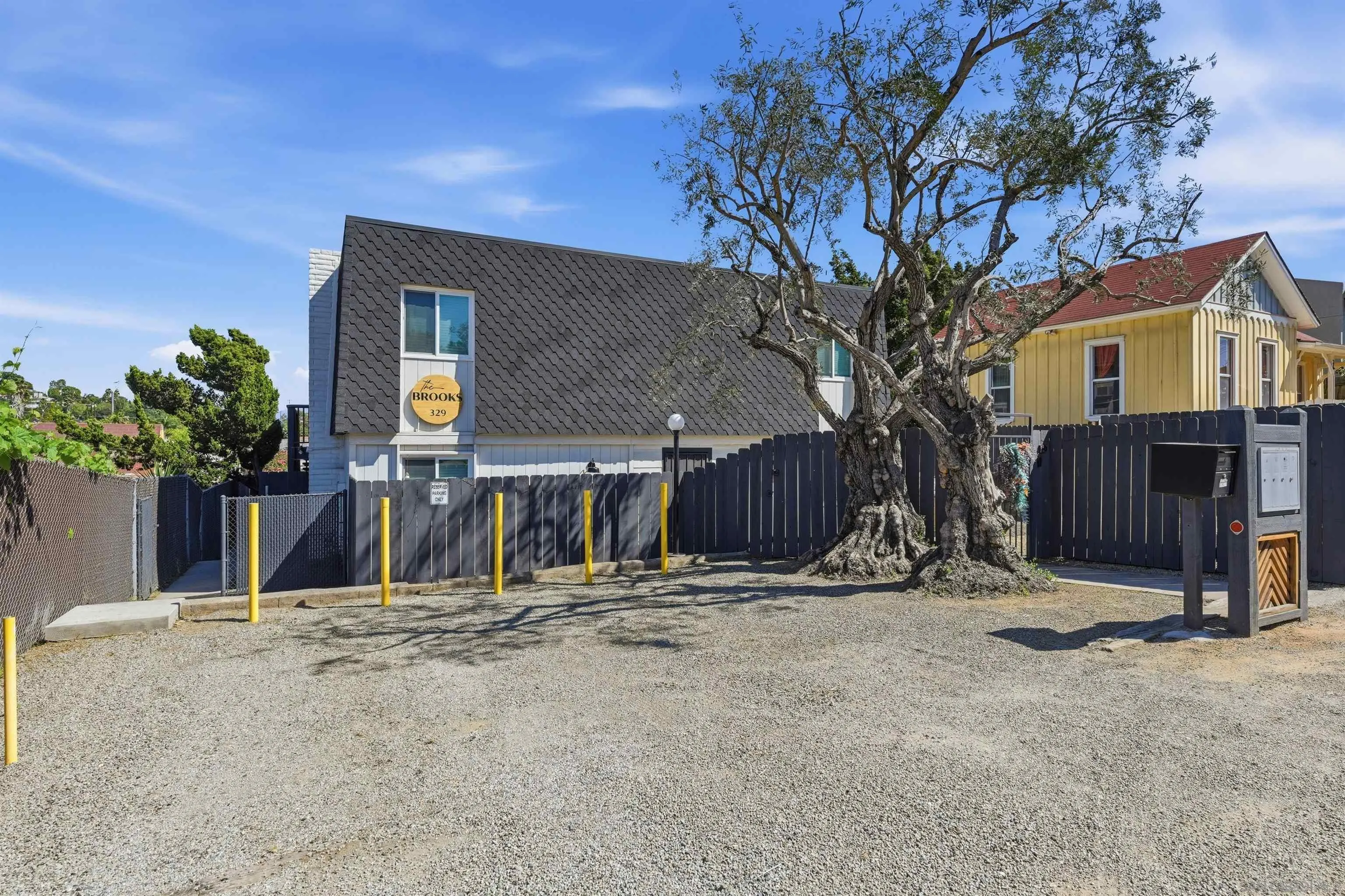 329 North Pico Avenue Fallbrook, CA 92028 - Photo 2 of 23 a view of a house with wooden fence and a large tree