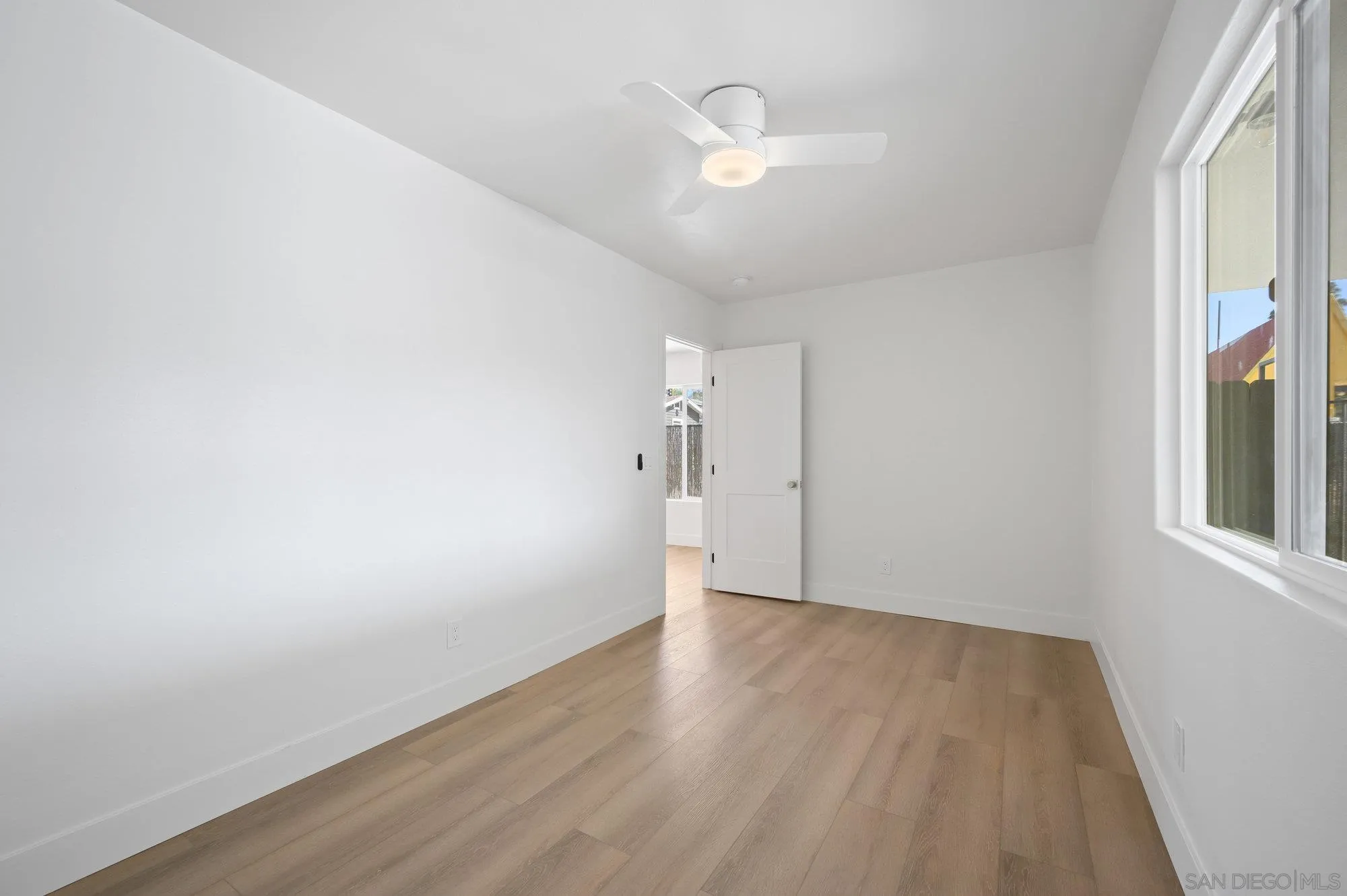 329 North Pico Avenue Fallbrook, CA 92028 - Photo 22 of 23 an empty room with wooden floor and windows