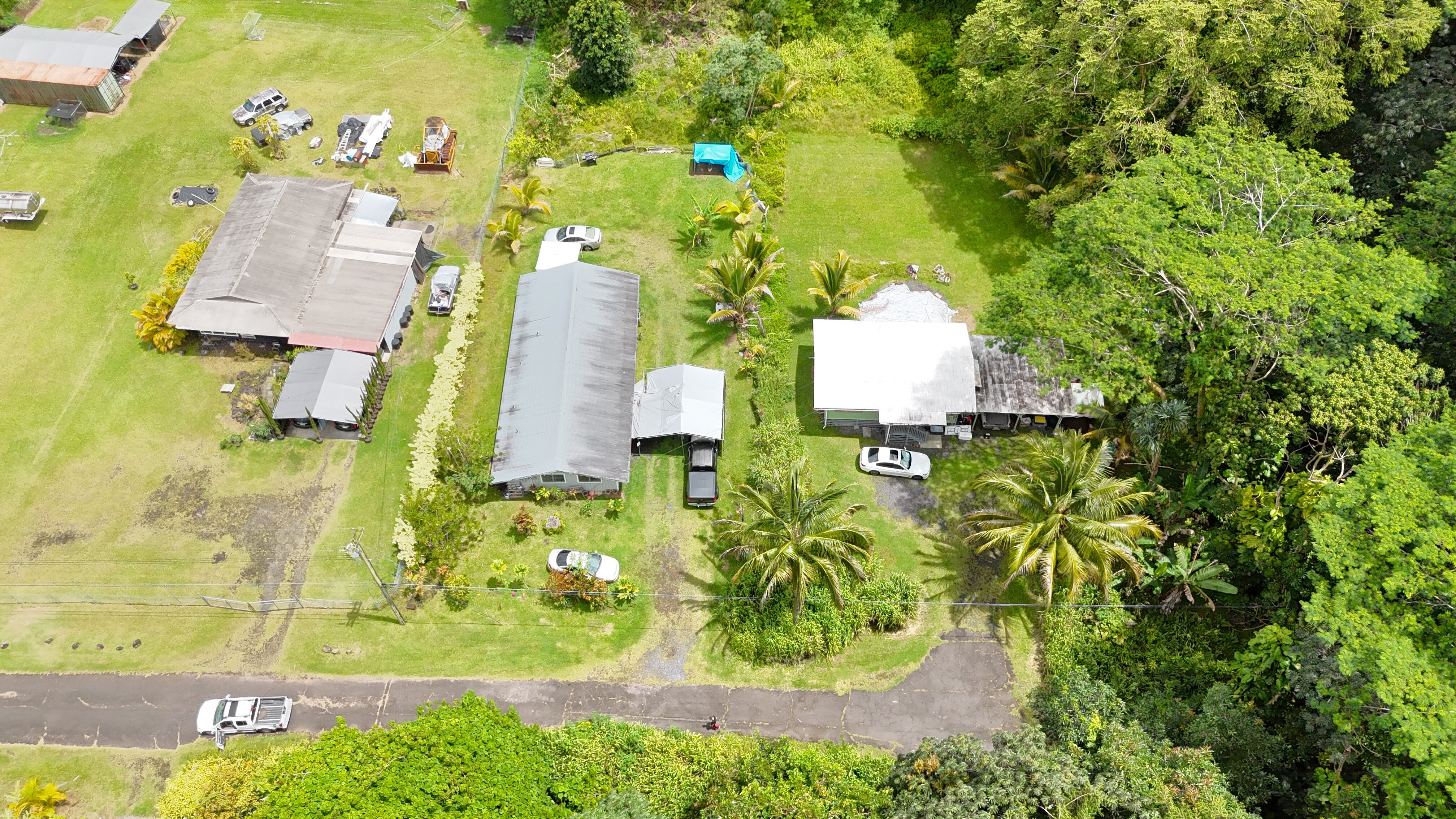 an aerial view of a residential houses with yard