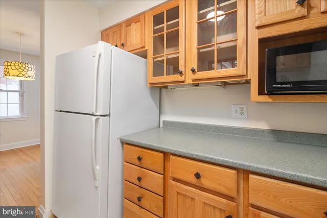 a kitchen with a refrigerator and a microwave