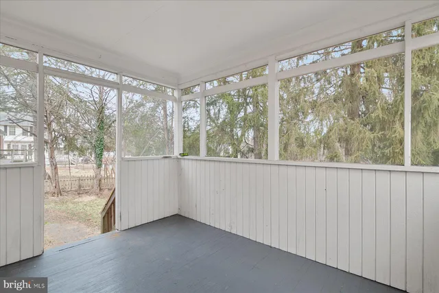 a view of a big room with wooden floor and doors