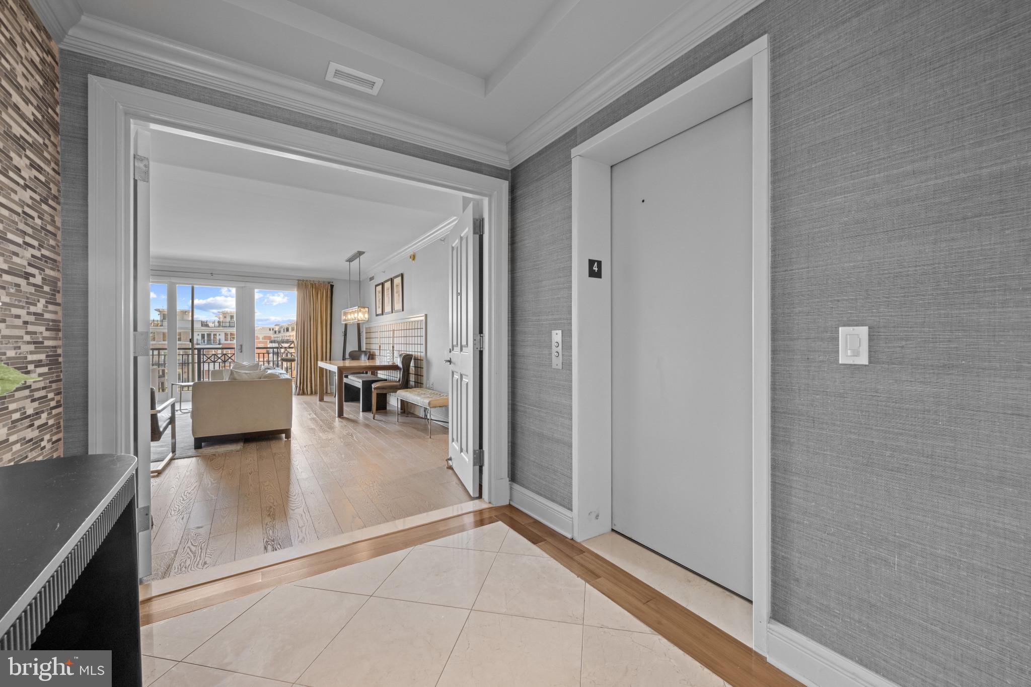 801 Key Highway, Unit 458 Baltimore, MD 21230 - Photo 2 of 48 a hallway with a dining table and chairs