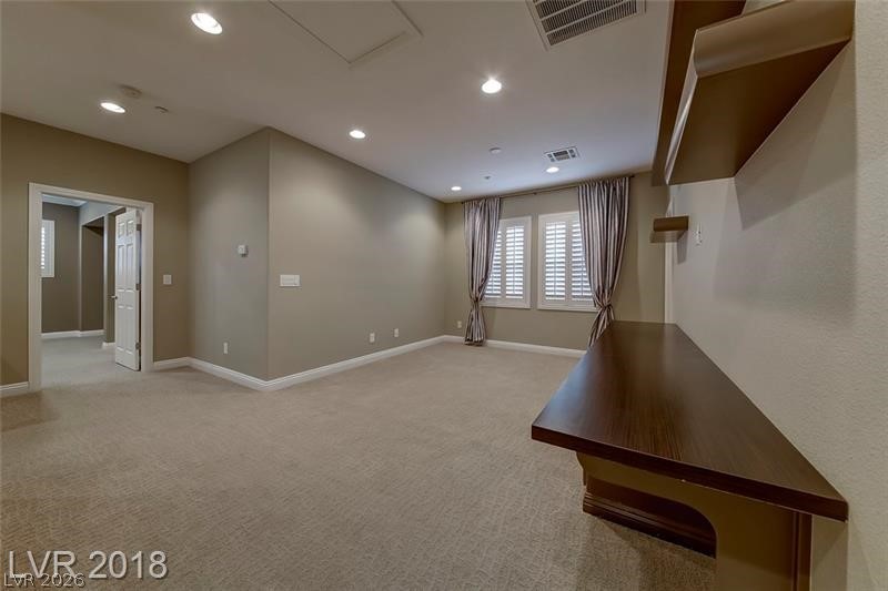 3144 Whitfeild Avenue Henderson, NV 89044 - Photo 18 of 55 Recessed lighting illuminates a versatile room with plush carpeting and elegant window shutters.