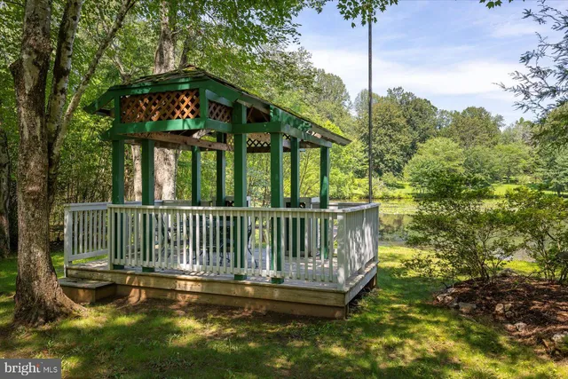a view of a balcony with wooden floor and outdoor seating