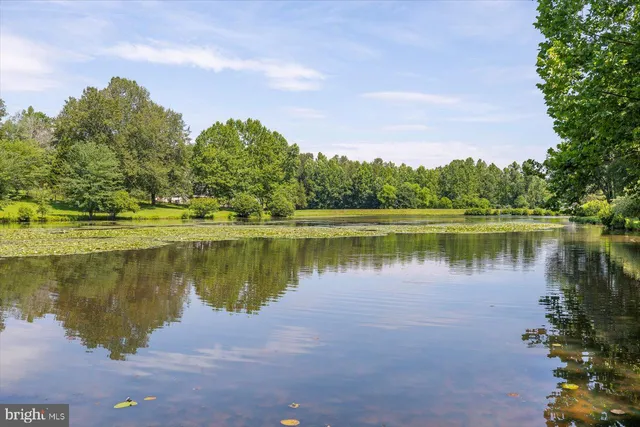 a view of a house with swimming pool and sitting area