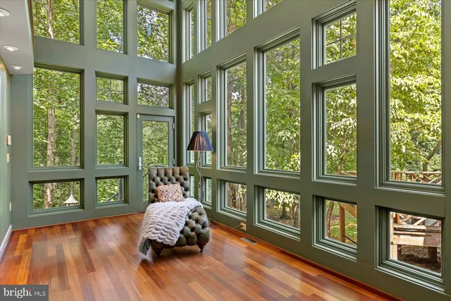 a living room with furniture tv and a large window
