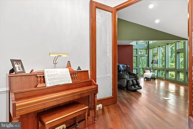 a front view of a house with a garden and trees
