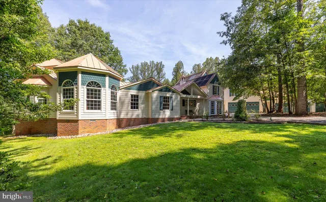 a front view of a house with a garden and porch