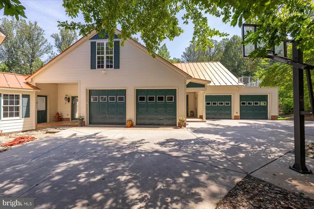 a front view of a house with yard and green space