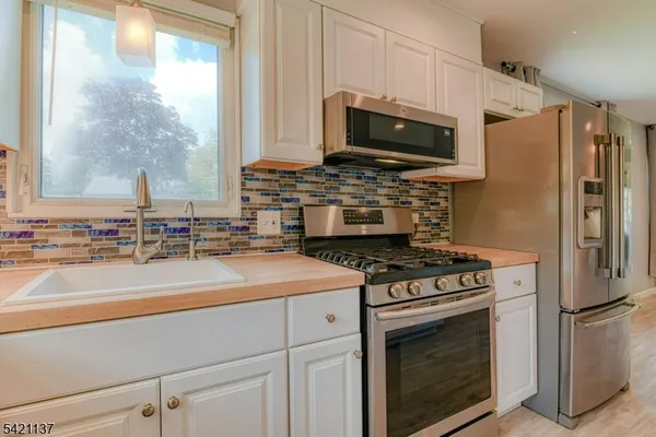 a kitchen with a stove microwave and refrigerator