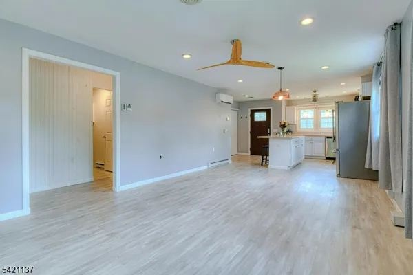 a view of a kitchen with a refrigerator and a sink