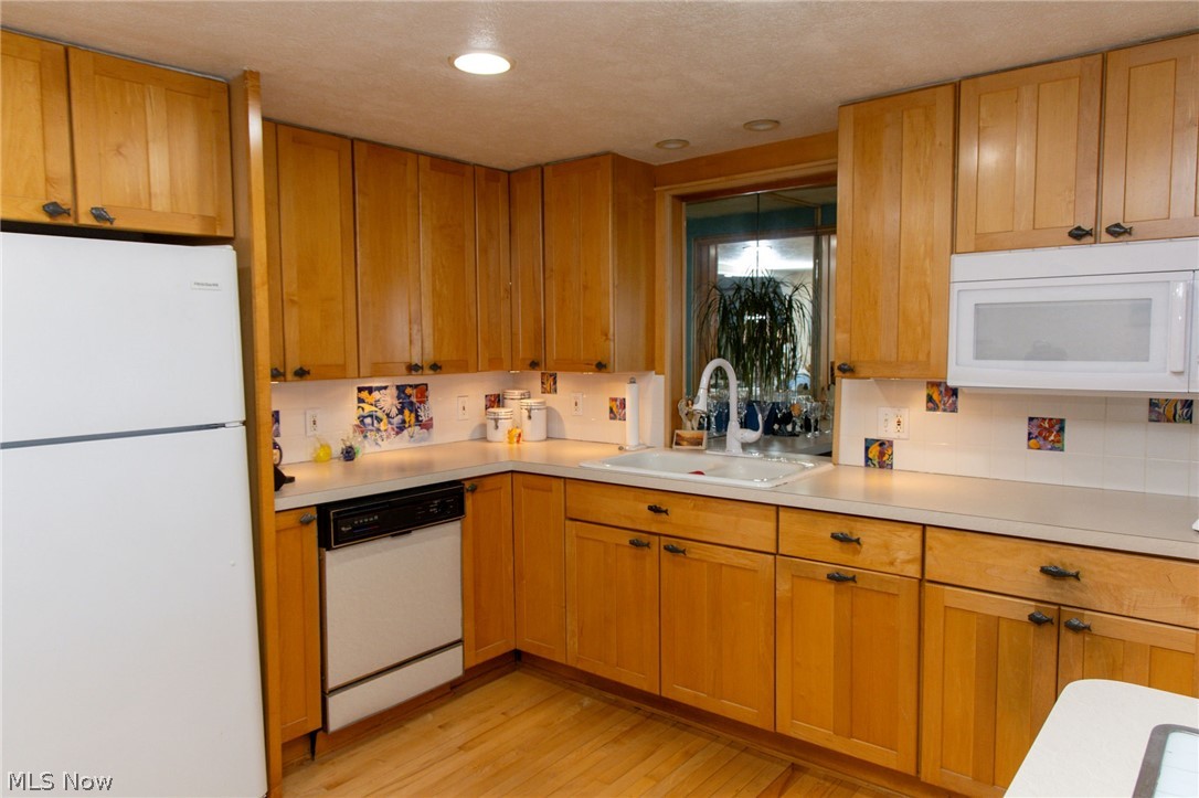 5467 Chapel Road Madison, OH 44057 - Photo 32 of 50 Kitchen featuring abundant wood-finish cabinetry, recessed lighting, and wood-finish flooring