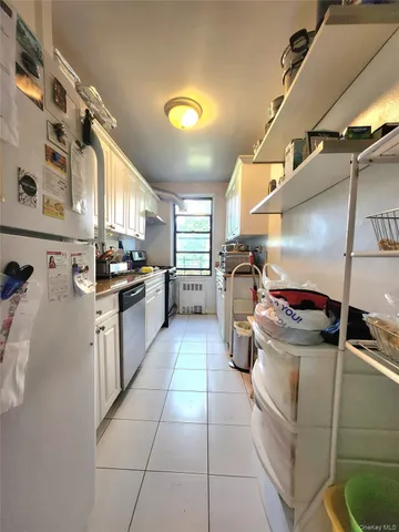 a kitchen with refrigerator and cabinets