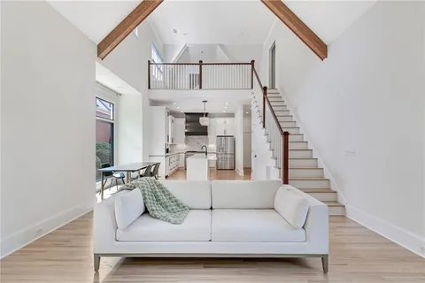 a living room with furniture a fireplace and a large window