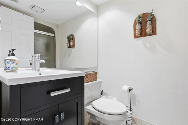 a bathroom with a toilet a sink and mirror