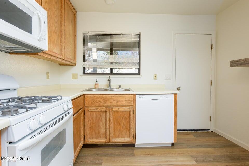 3532 Haystack Drive Carson City, NV 89705 - Photo 21 of 34 a kitchen with granite countertop cabinets stainless steel appliances and a wooden floor
