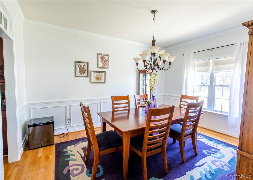 5925 Springmount Road Chesterfield, VA 23832 - Photo 9 of 35 a view of a dining room with furniture a chandelier and wooden floor