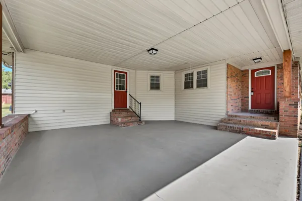 a backyard of a house with table and chairs