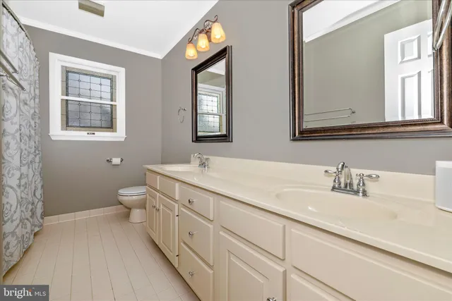 a living room with furniture a table and kitchen view