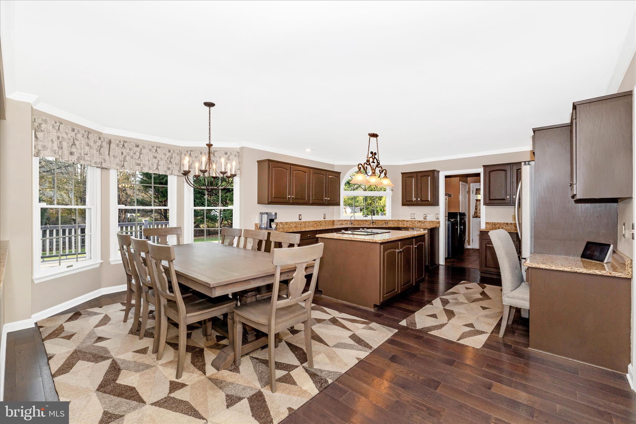 13514 Paradise Church Road Hagerstown, MD 21742 - Photo 10 of 56 a dining room with furniture a rug a flat screen tv and a floor to ceiling window