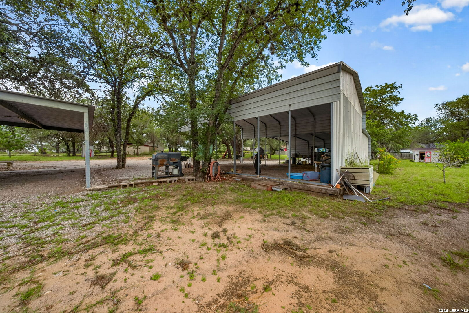 23398 Mathis Road Elmendorf, TX 78112 - Photo 17 of 18 a view of a yard with a house in the background