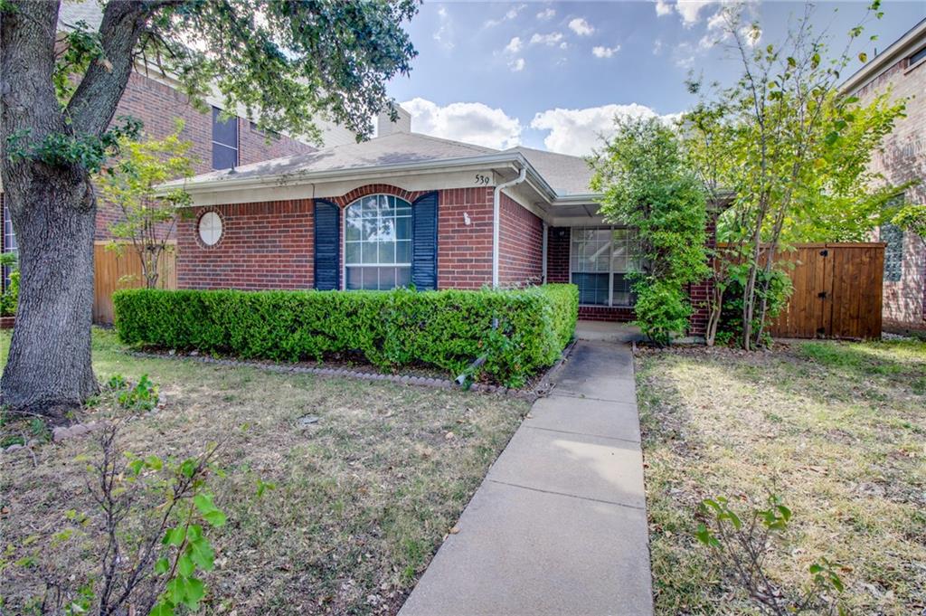539 Raintree Circle Coppell, TX 75019 - Photo 1 of 1 a front view of a house with garden