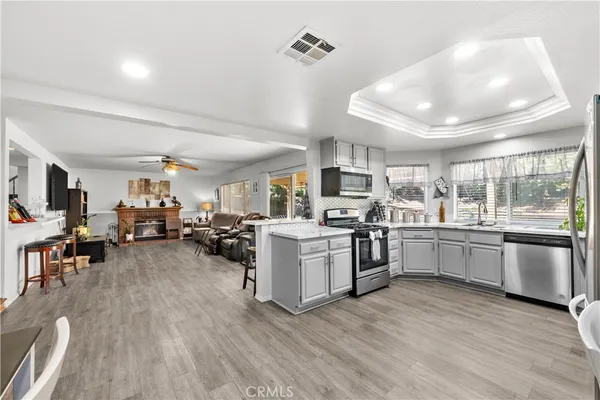 a kitchen with stove and wooden floor