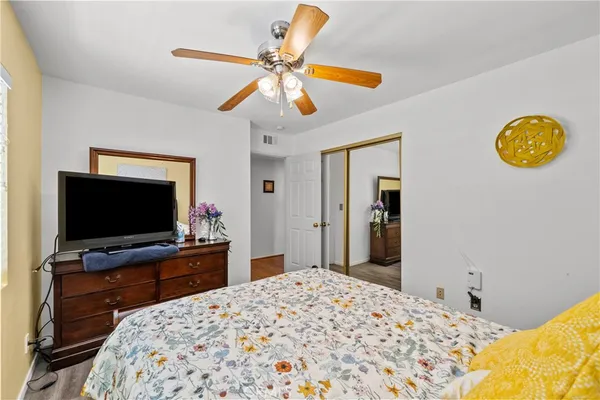 a bedroom with a bed and a flat screen tv
