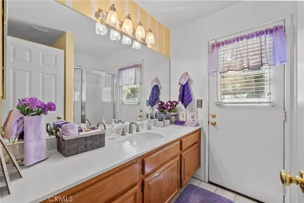 a bathroom with a sink vanity and a mirror
