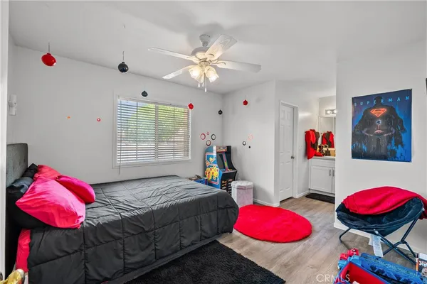 a bedroom with bed and a chandelier