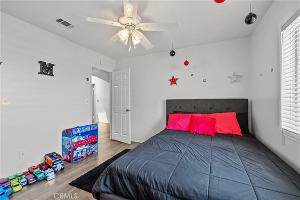 a bedroom with furniture and a chandelier
