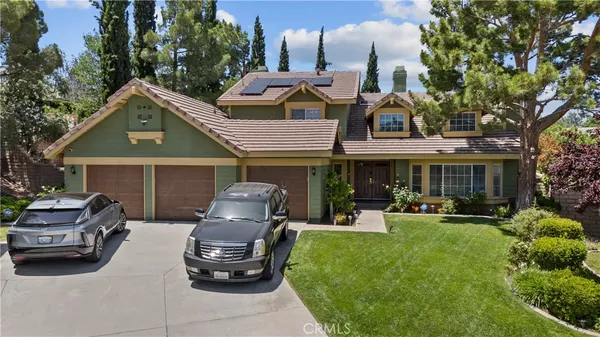 a front view of a house with a garden and patio