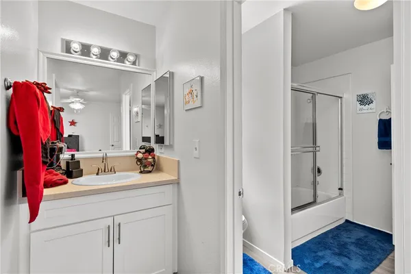 a bathroom with a sink vanity and a mirror