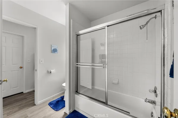 a bathroom with a glass shower door
