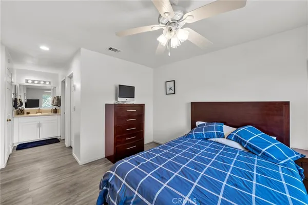 a bedroom with a bed and a chandelier