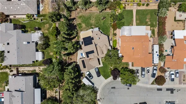 an aerial view of a house with a yard