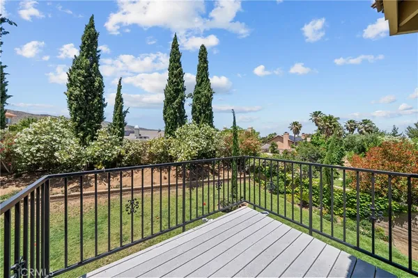 a view of a patio with a table chairs and backyard