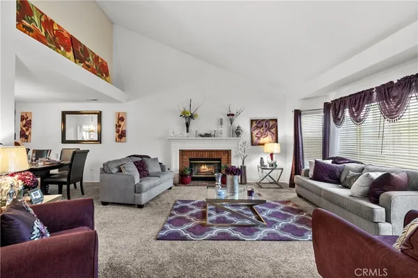 a living room with furniture a rug and a fireplace