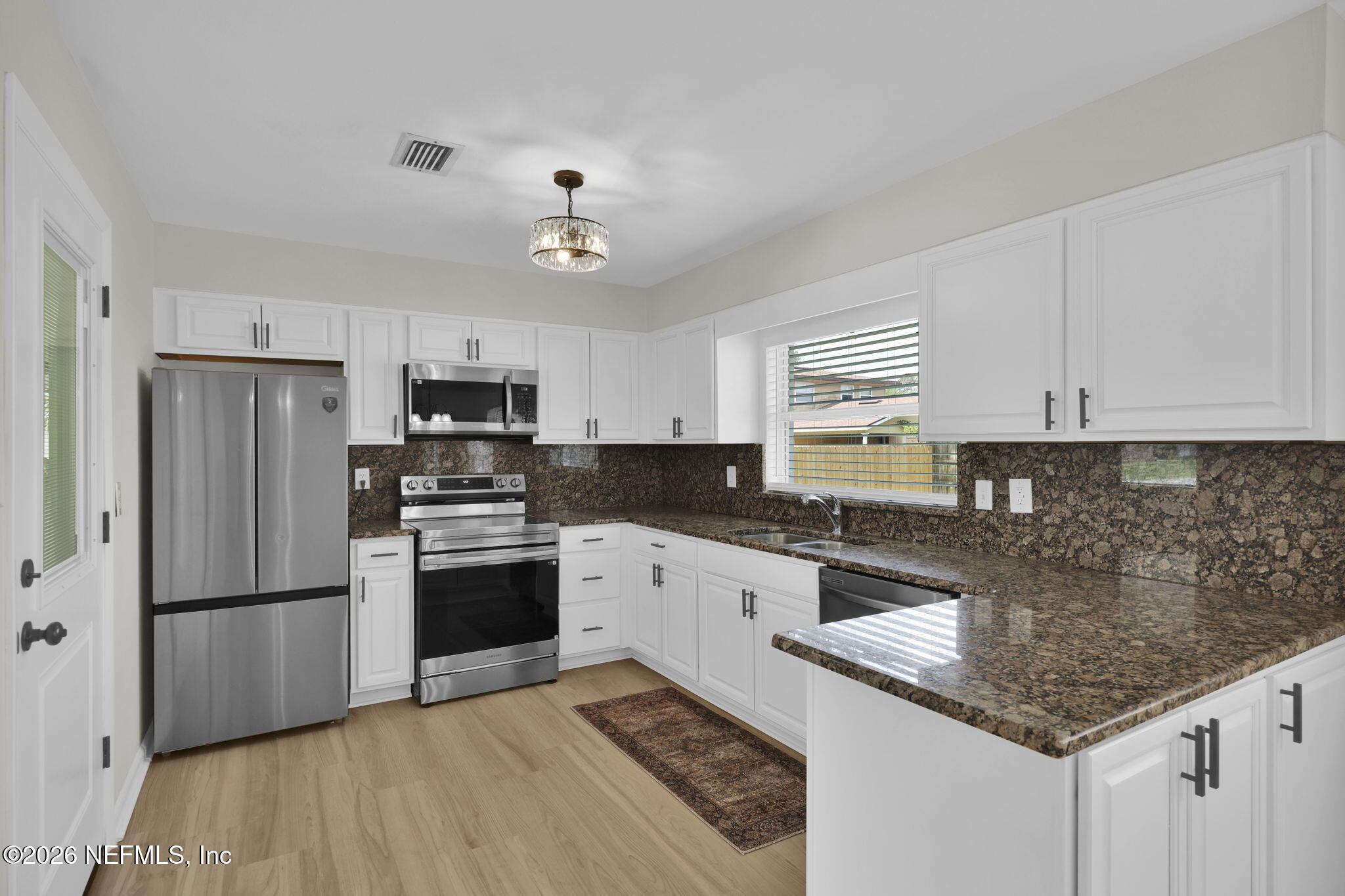 8544 Sanchez Road Jacksonville, FL 32217 - Photo 26 of 46 a kitchen with stainless steel appliances granite countertop a sink stove and refrigerator