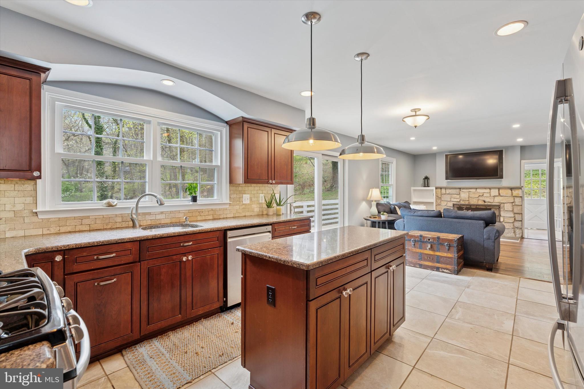 78 Peddrick Road Wayne, PA 19087 - Photo 11 of 47 a kitchen with stainless steel appliances granite countertop a sink a stove and a wooden cabinets