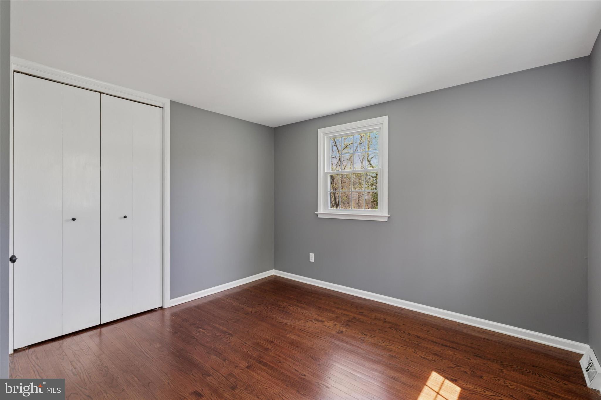78 Peddrick Road Wayne, PA 19087 - Photo 29 of 47 a view of an empty room with wooden floor and a window