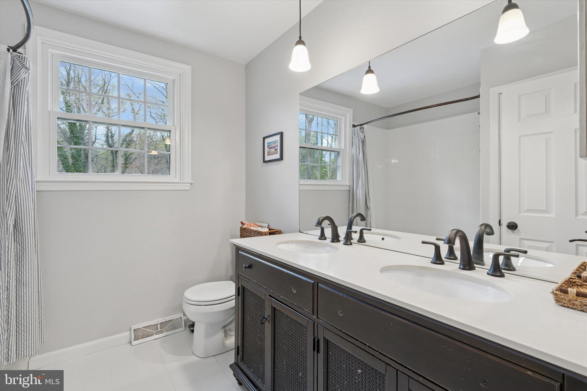 78 Peddrick Road Wayne, PA 19087 - Photo 30 of 47 a bathroom with a double vanity sink toilet and a mirror