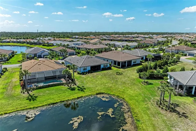 an aerial view of a house with yard swimming pool and outdoor seating