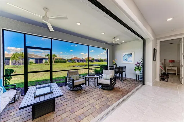 a view of an empty room with wooden floor and a windows