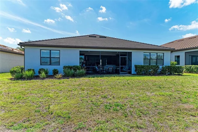 a front view of a house with swimming pool and glass windows