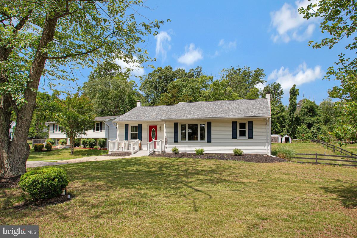 976 Shore Acres Road Arnold, MD 21012 - Photo 2 of 40 a front view of house with yard and trees around