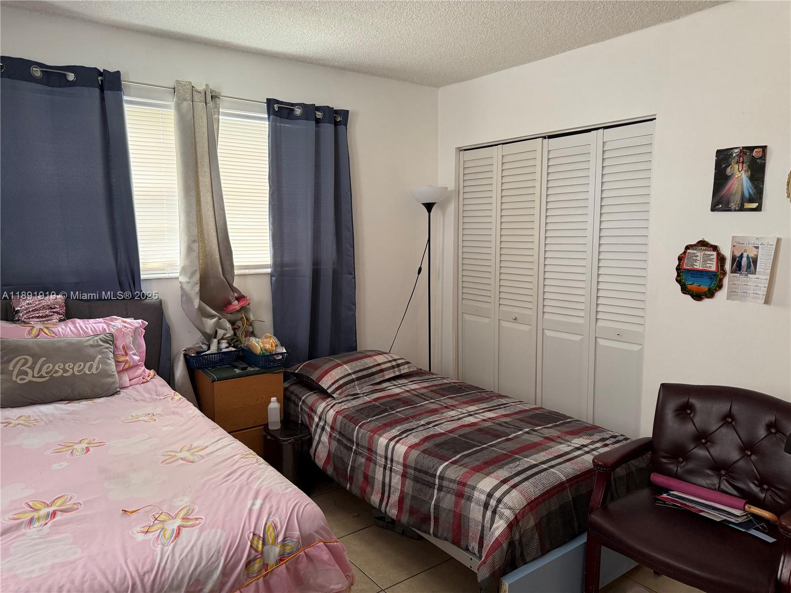 1100 Northeast 1st Court, Unit 120 Hallandale Beach, FL 33009 - Photo 13 of 45 a bedroom with two beds and a window