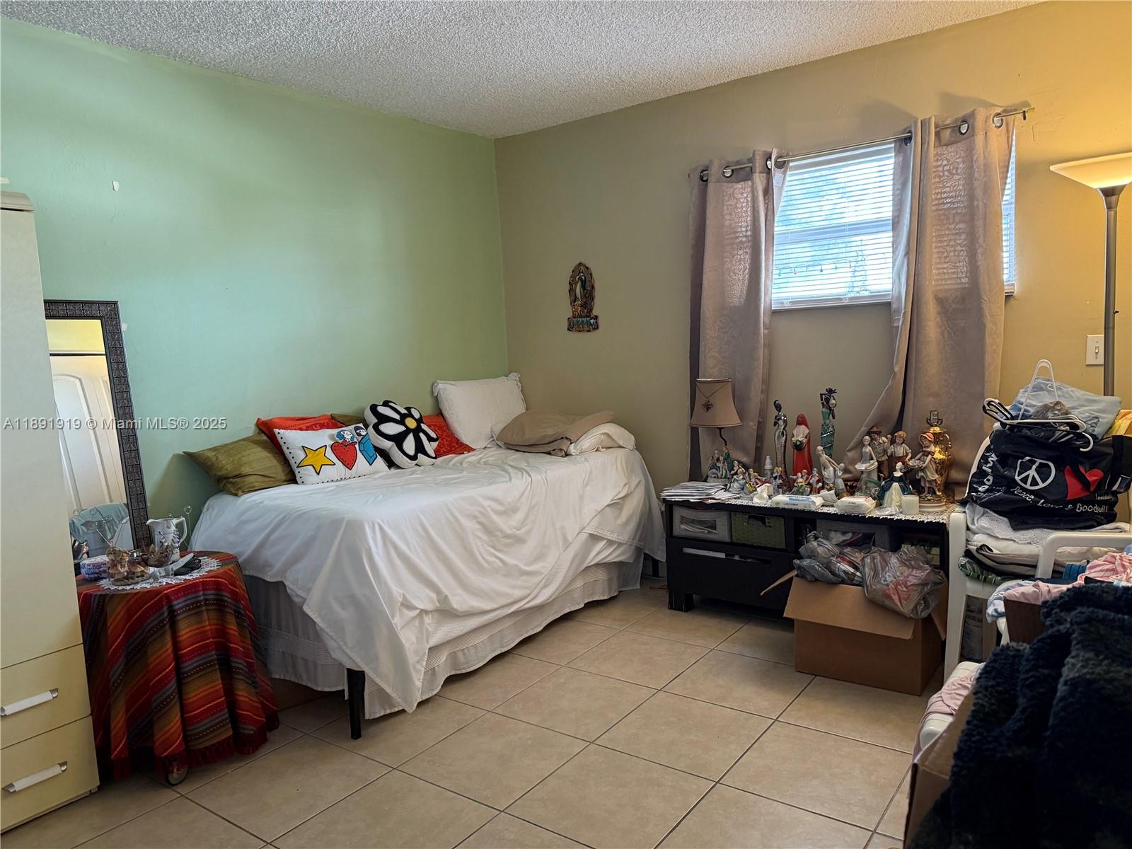 1100 Northeast 1st Court, Unit 120 Hallandale Beach, FL 33009 - Photo 16 of 45 a bedroom with a bed and wooden floor