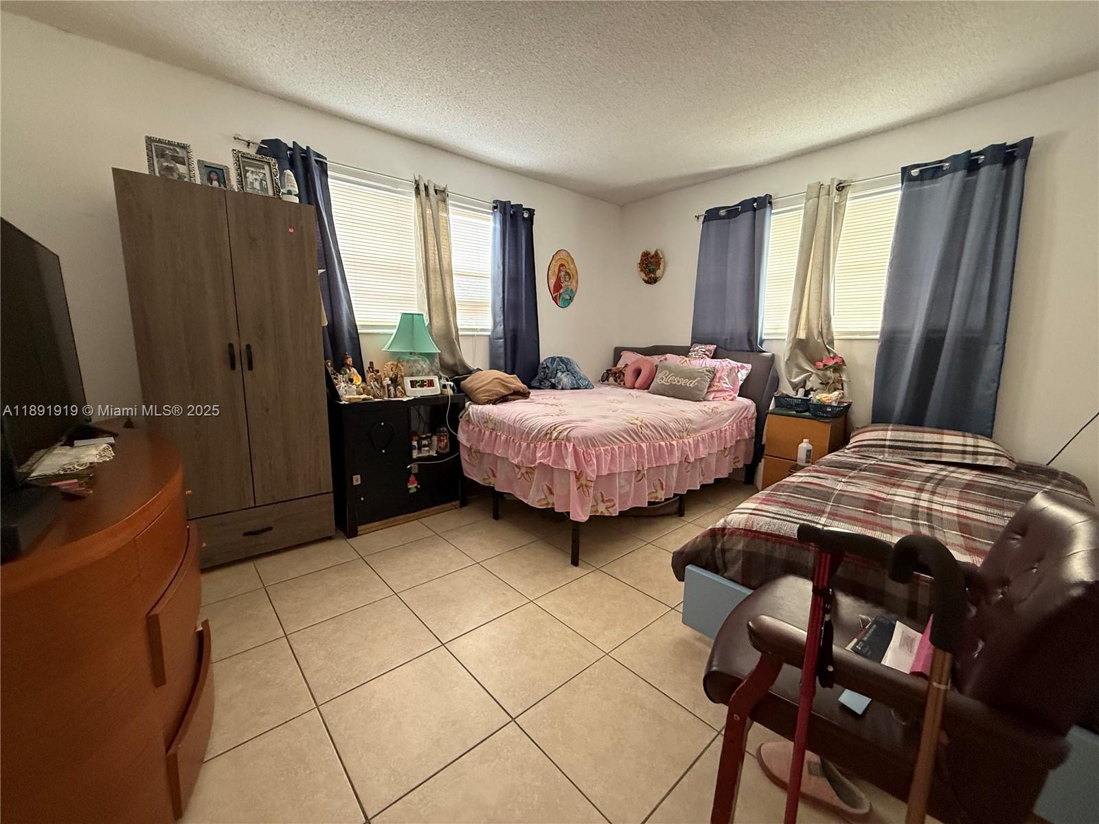 1100 Northeast 1st Court, Unit 120 Hallandale Beach, FL 33009 - Photo 20 of 45 a bedroom with two beds and a dresser